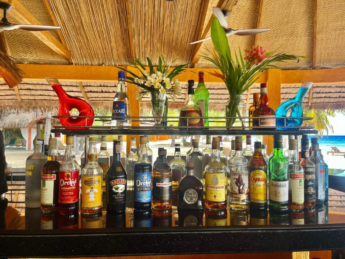 Coco Grove Beach Resort, Siquijor Island エクステリア 写真 Rum bottles at a bar in the Caribbean